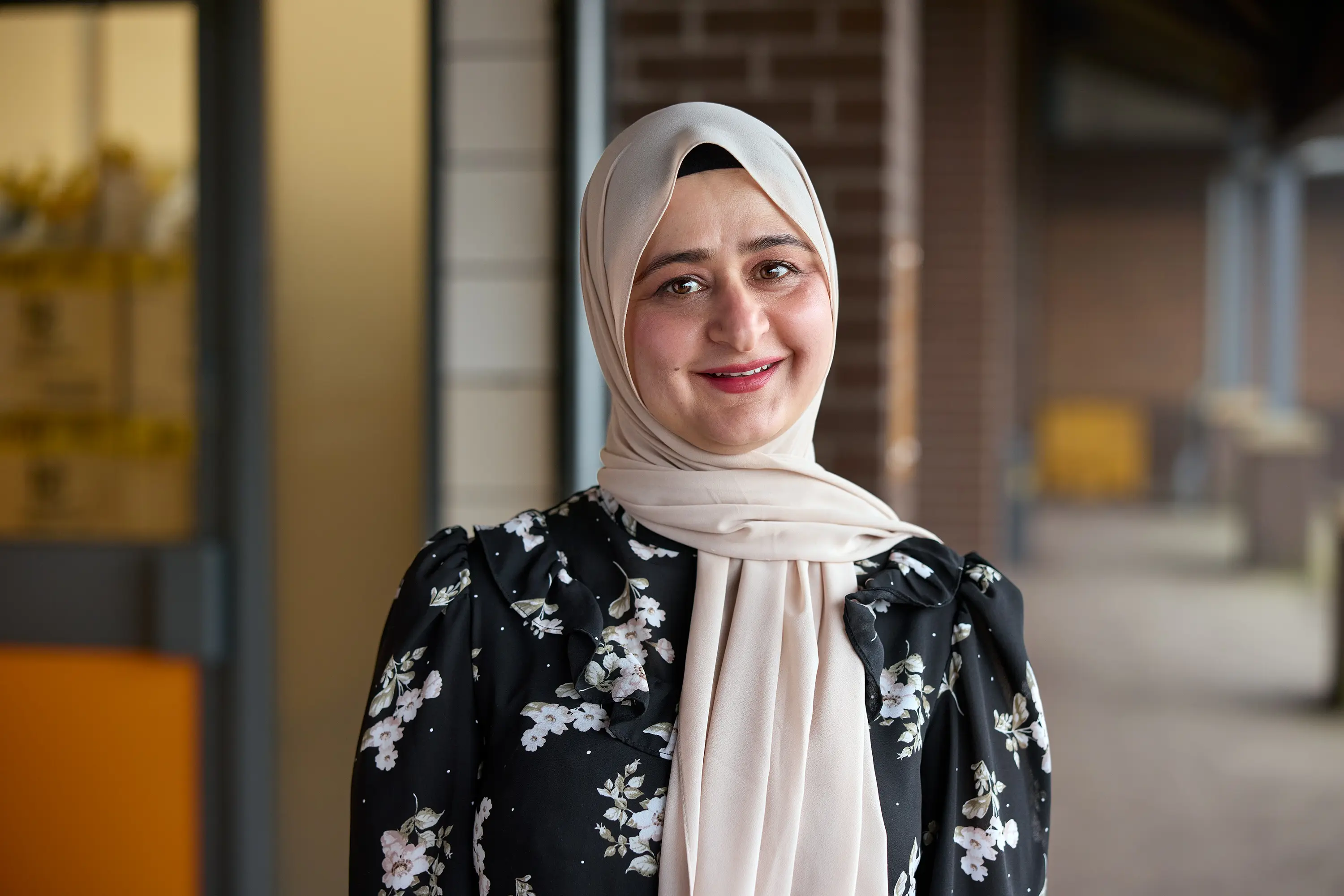 Community Shop Tong Street member smiling outside the store