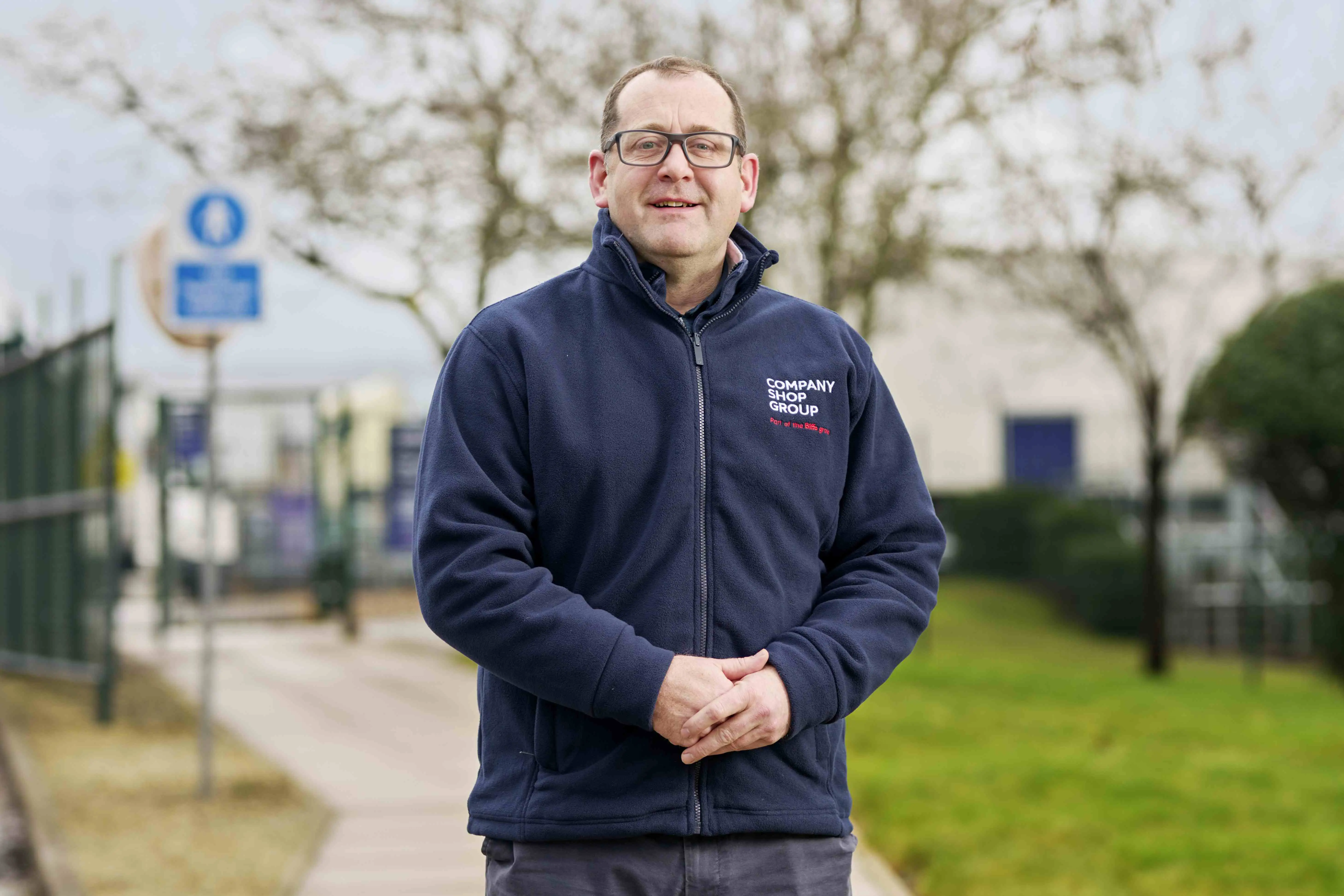 Chris Burns, MD of Company Shop Group, wearing a branded fleece outside the Wentworth head office.