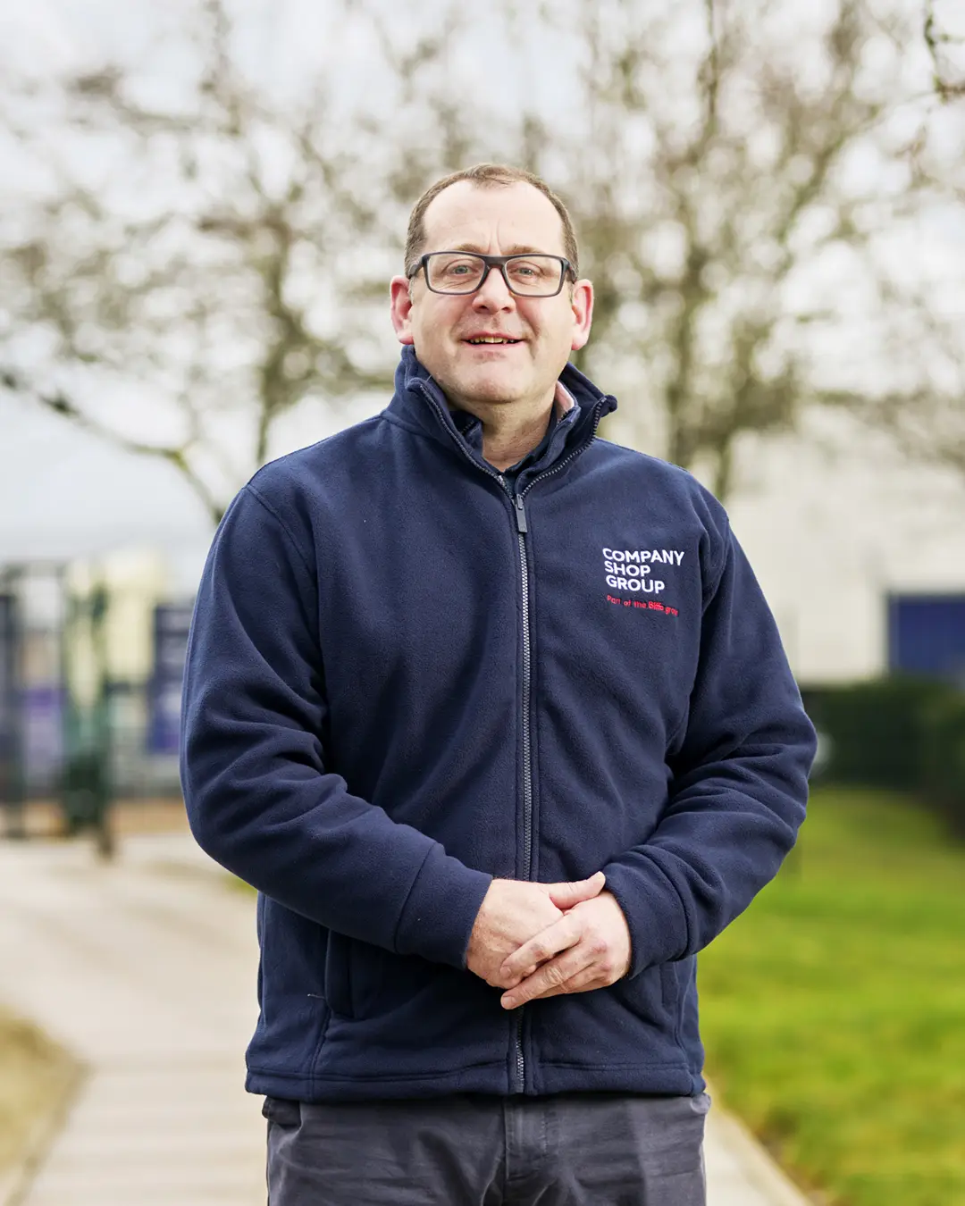 Chris Burns, MD of Company Shop Group, wearing a branded fleece outside the Wentworth head office.