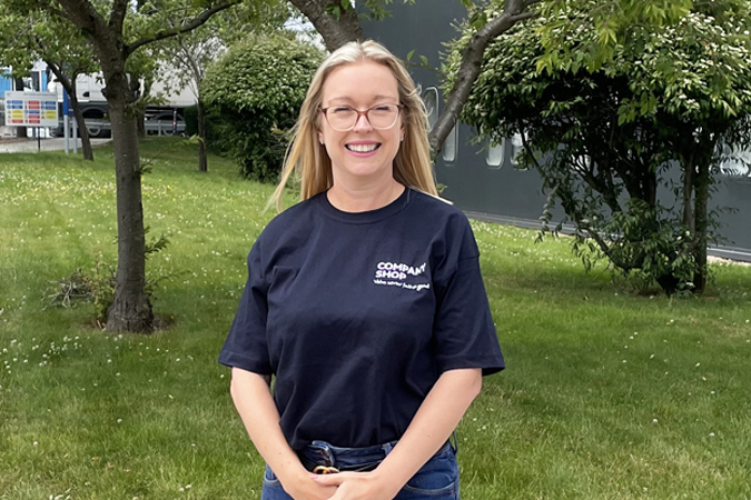 Holly Mobley, Commercial Director, stands in the sunshine outside Company Shop Group.