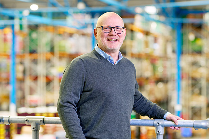 Lee Wood, Trading Director, stands in the Company Shop surplus warehouse.