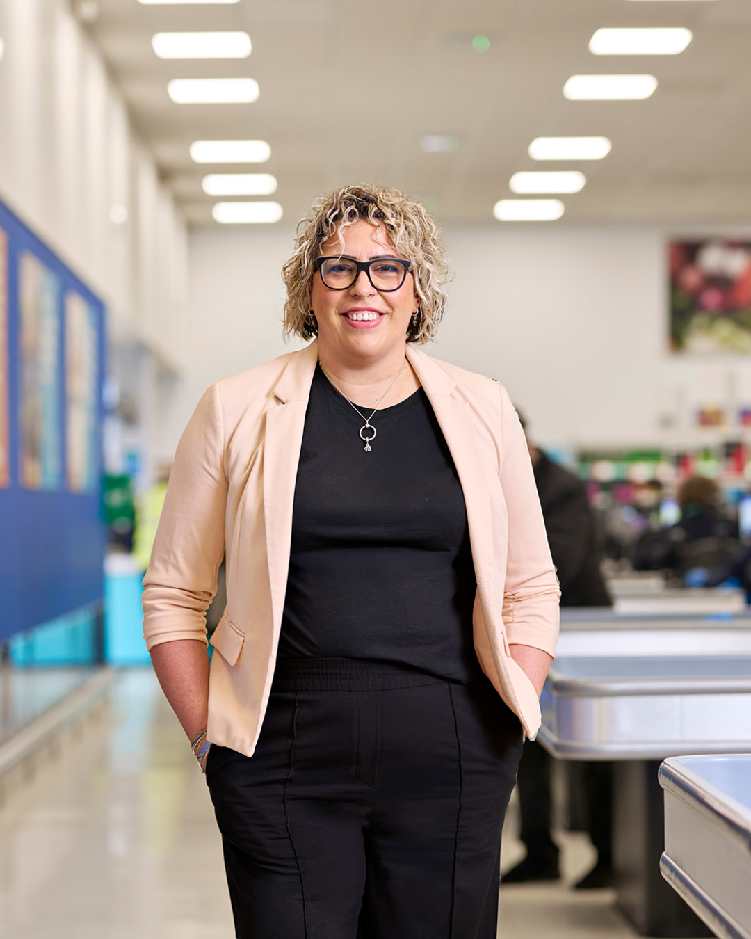 Gemma Edlin, Retail Director at Company Shop, stands in a brightly lit shop.